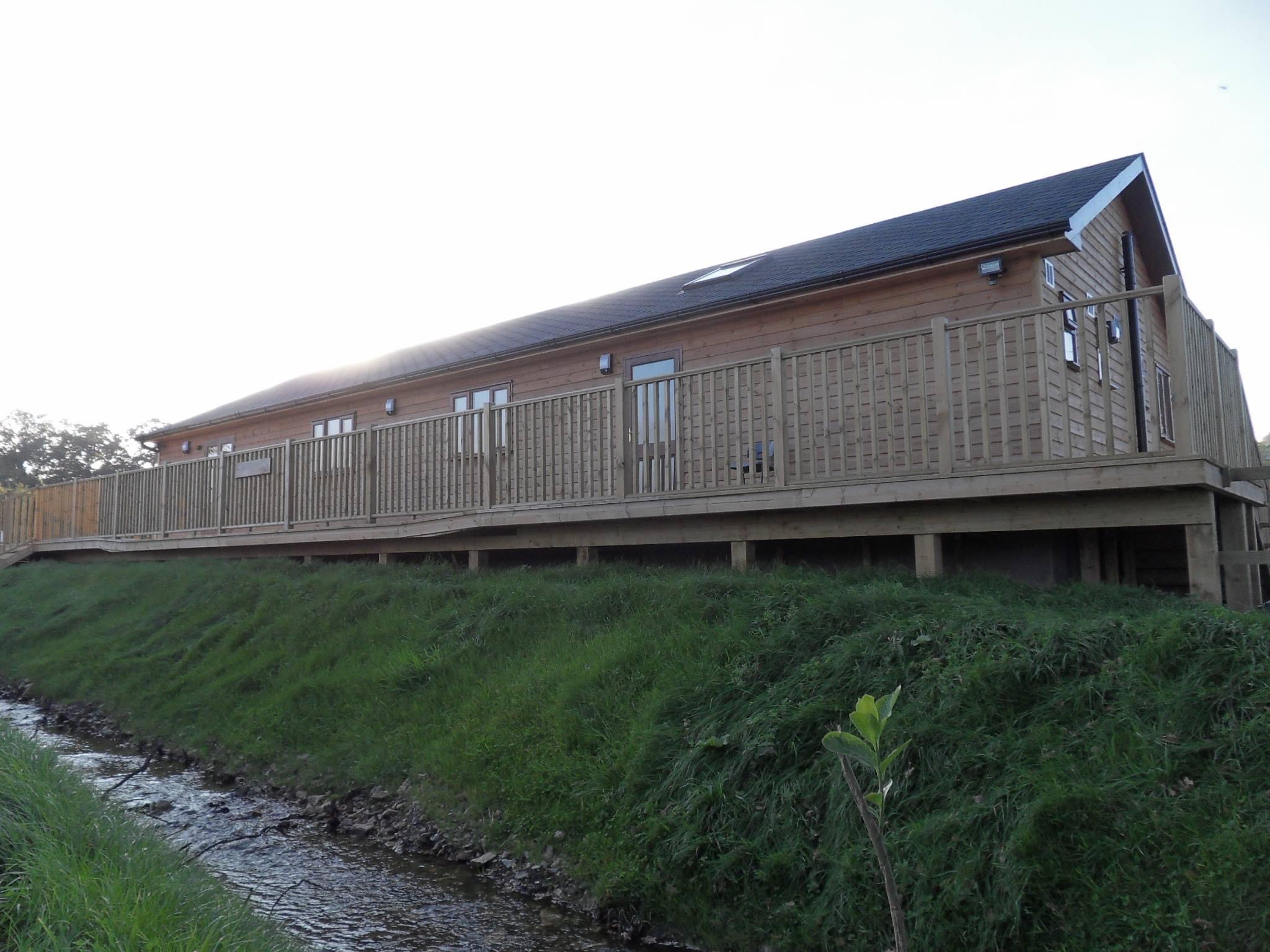  The rear elevation of the ‘Village Hall’ complete with decked area, to enable disabled access and to enjoy the view - Harris Timber Products